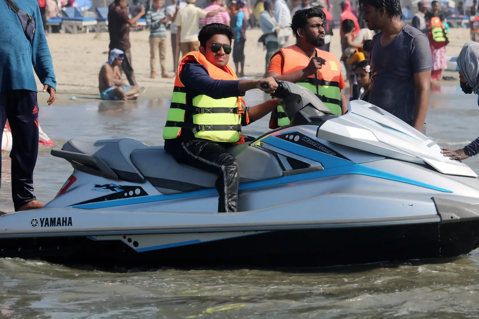 Anik Mahmud operating a jet ski while wearing a life jacket.