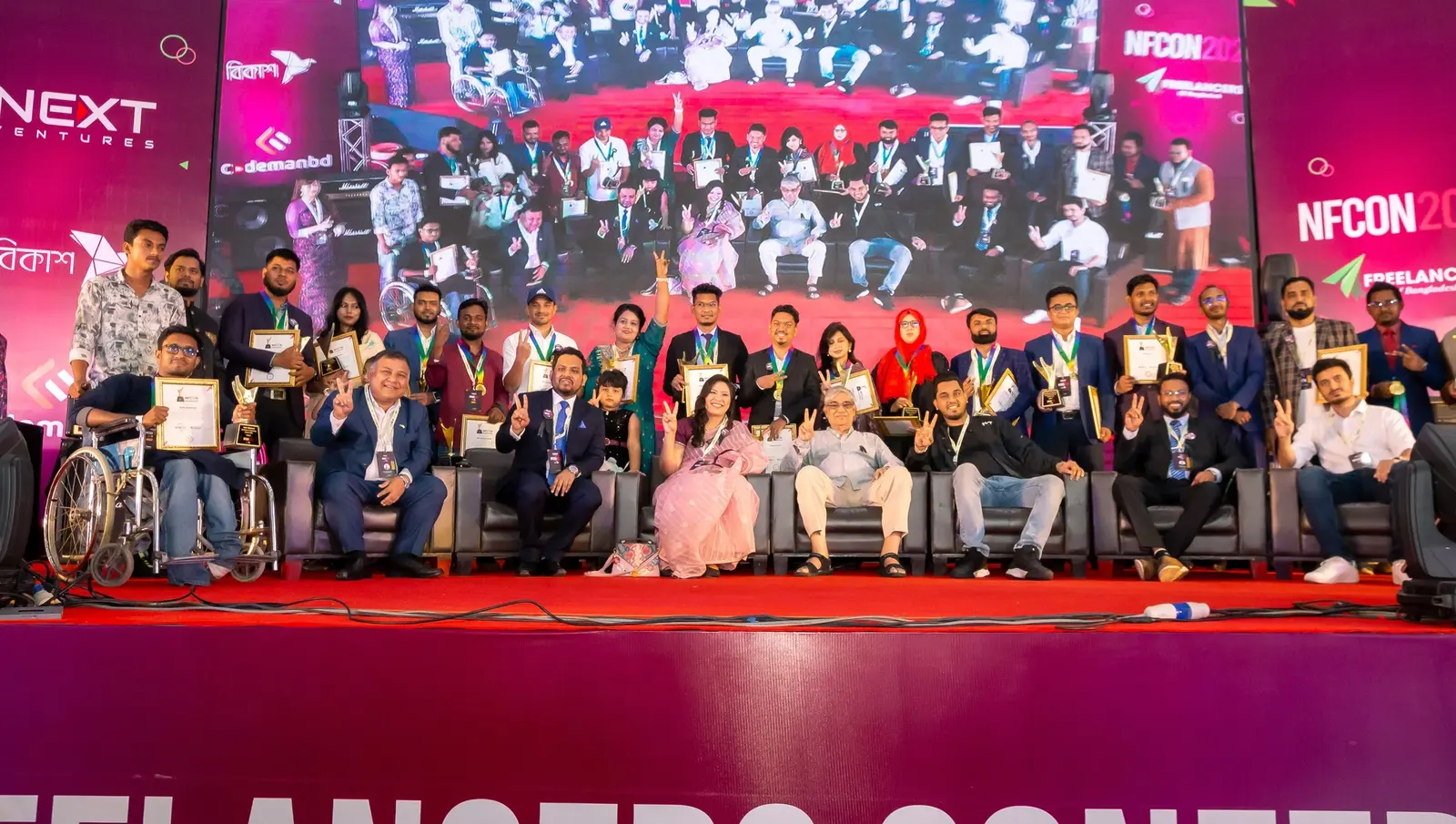Anik Mahmud with award recipients and guests on the National Freelancers Conference stage in 2023.