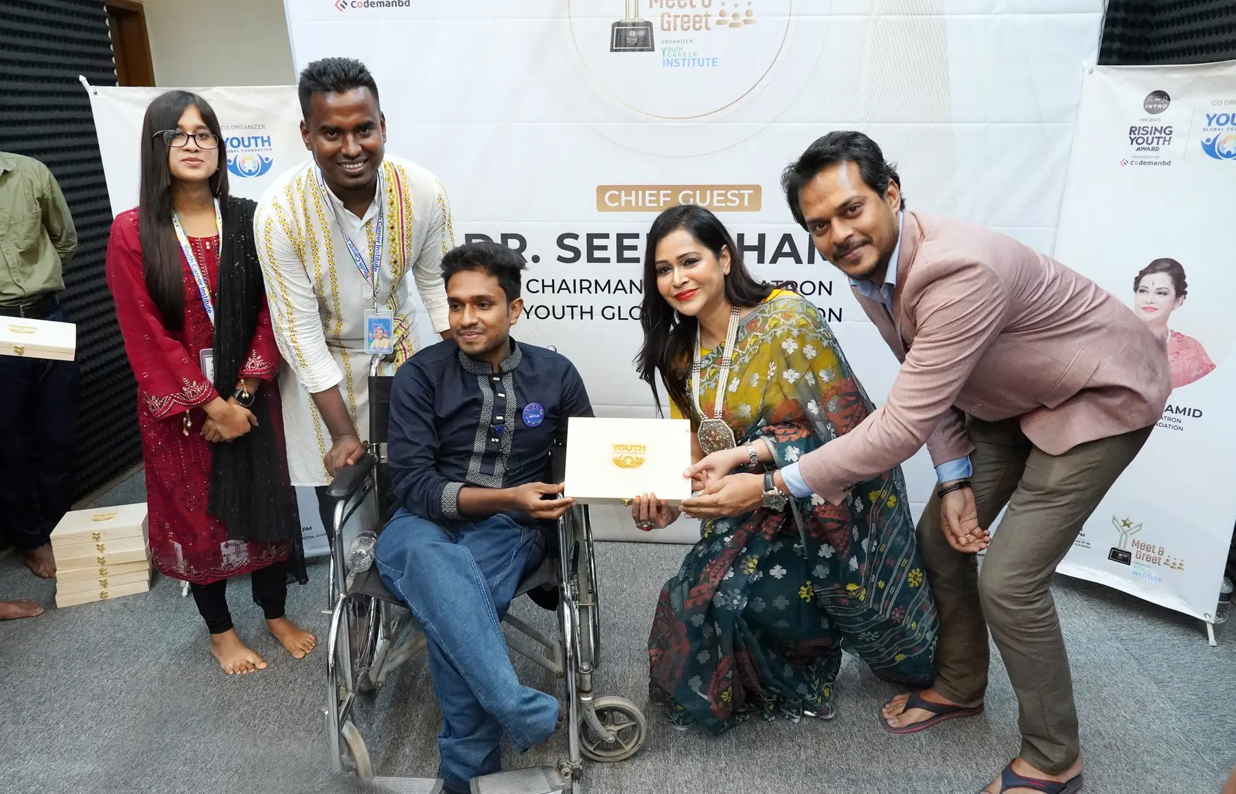Anik Mahmud receiving a commemorative item during the Rising Youth Award Meet and Greet in 2022.