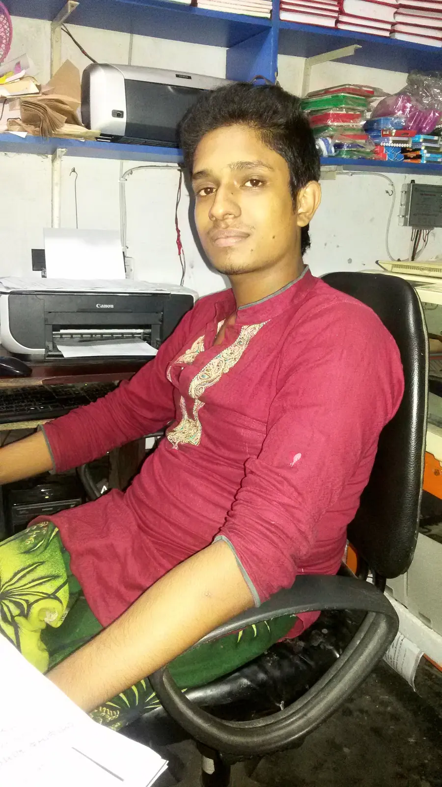 Anik Mahmud beside a printer inside his small shop in 2013.
