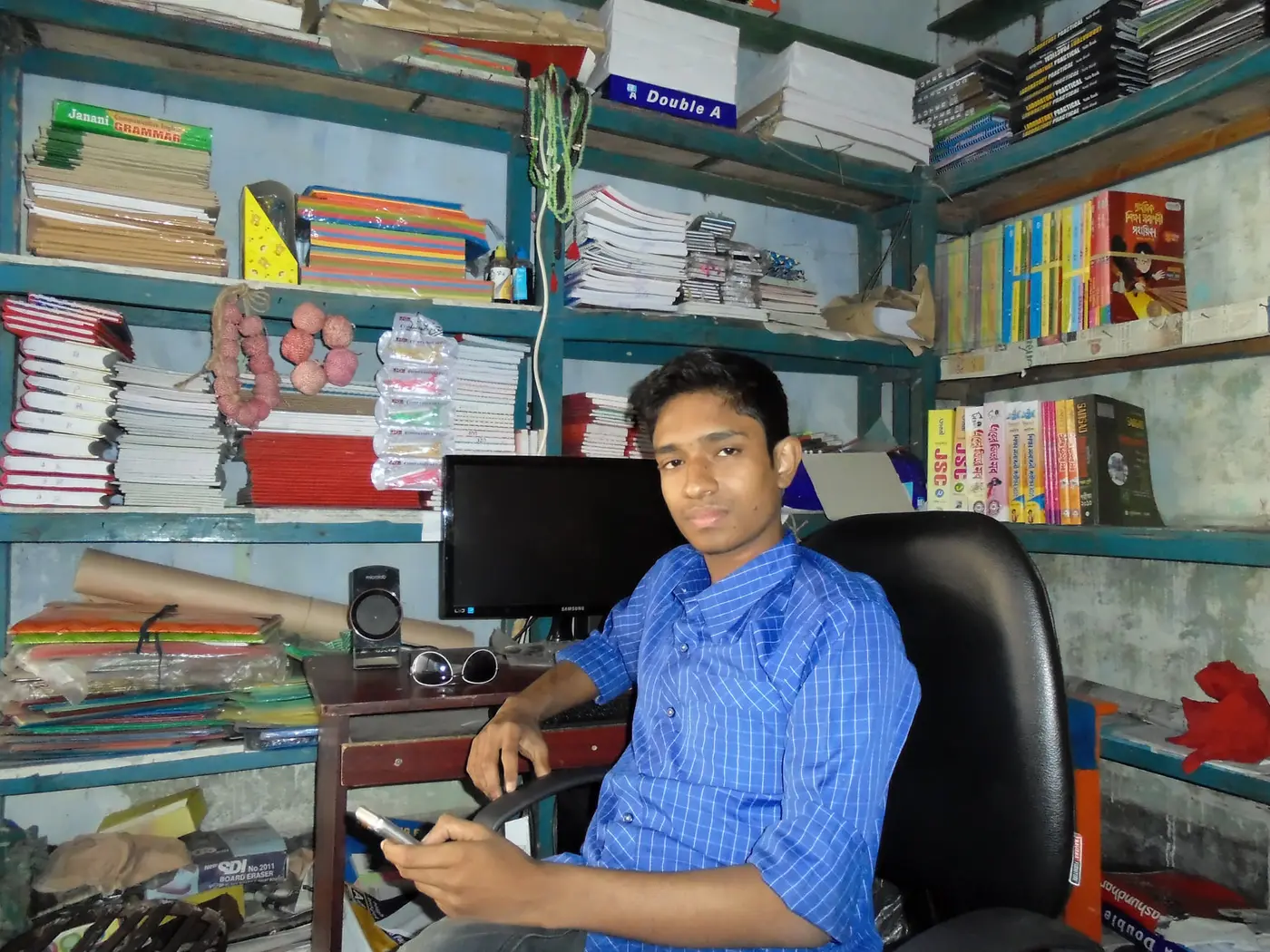 Anik Mahmud in his shop while preparing for the SSC examination in 2014.