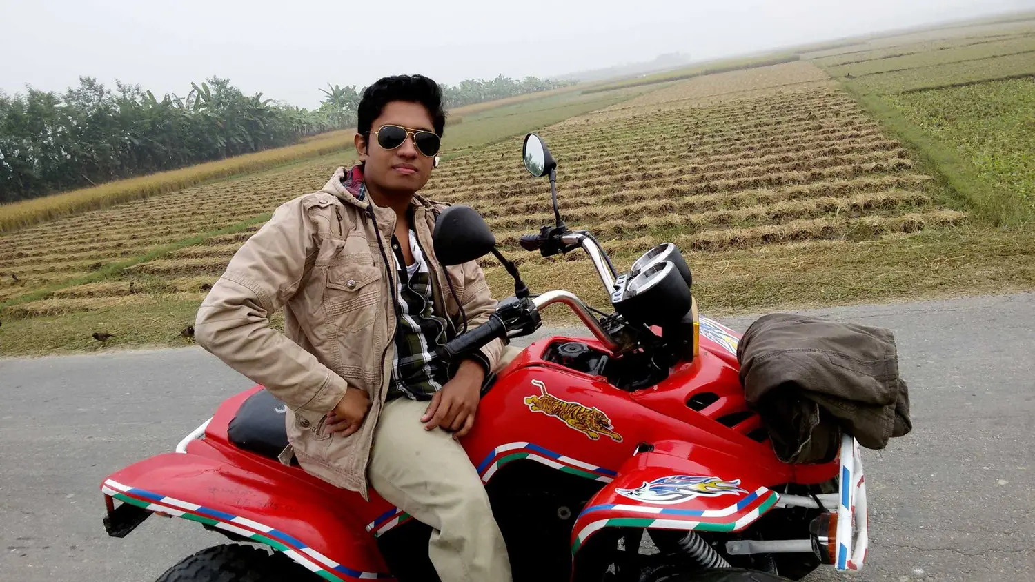 Anik Mahmud seated on a red ATV beach bike in 2015.
