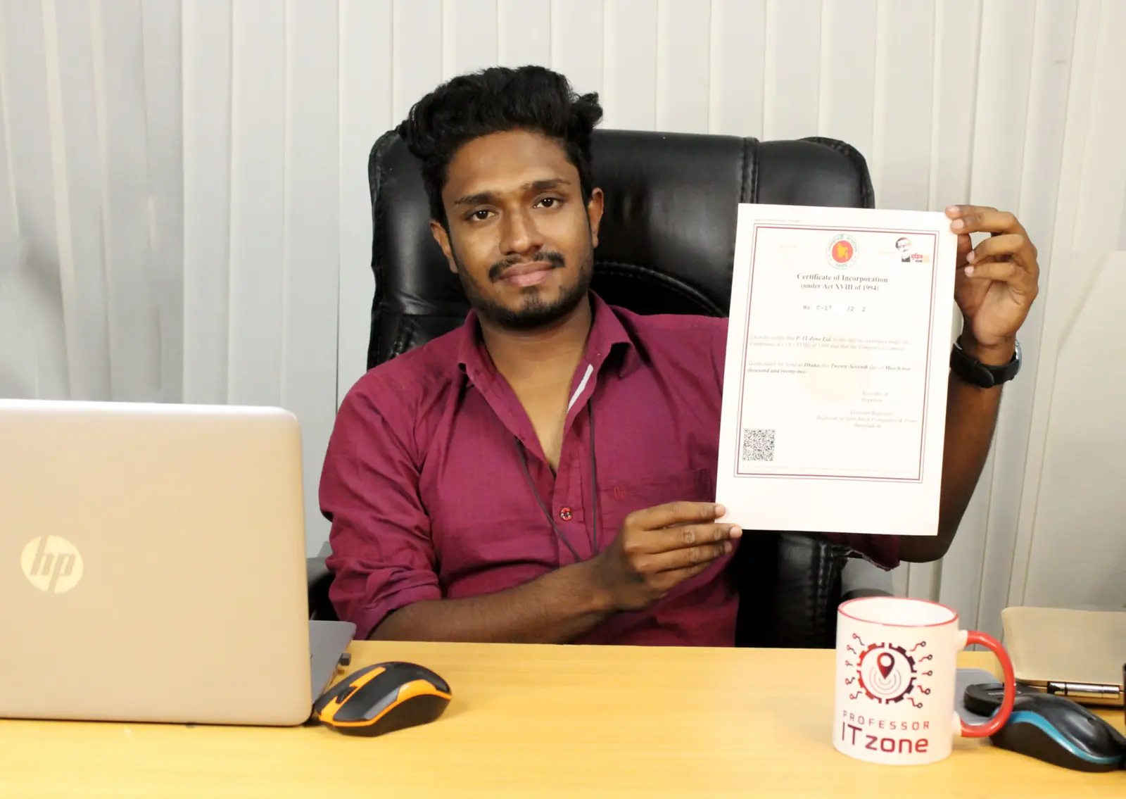 Anik Mahmud holding a professional recognition document inside Professor IT Zone in 2022.