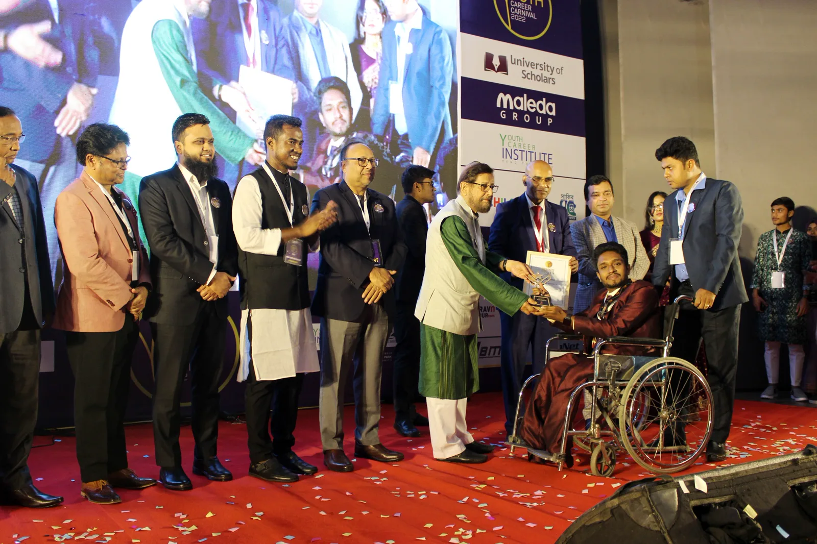 Anik Mahmud receiving the Rising Youth Award 2022 on stage.