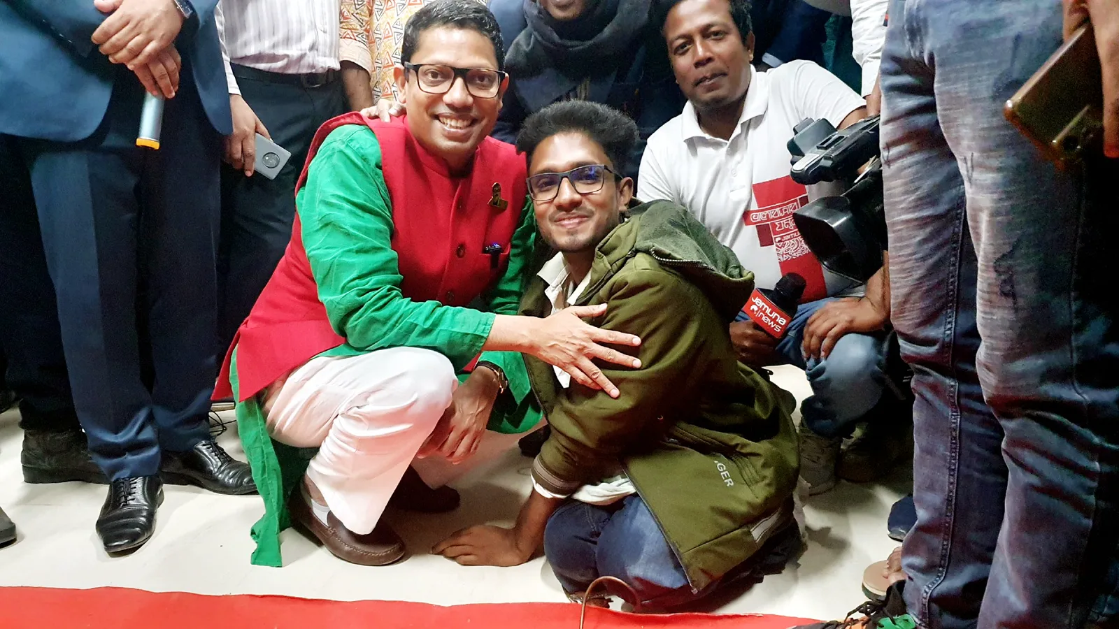 Zunaid Ahmed Palak kneeling beside Anik Mahmud at the Kushtia Circuit House on 9 March 2024.